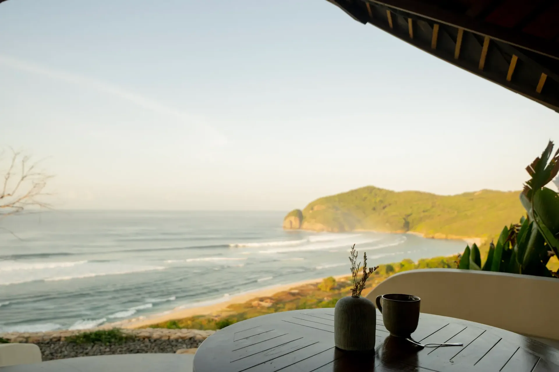 Ocean view breakfast setting with coffee and coastal panorama at Elysian Cove